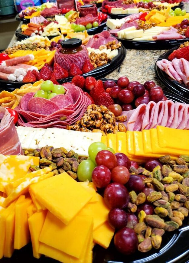 charcuterie boards at Bella Rosa Venue owner Tricia Bell near Tulsa with bread cheese, fruit, sausage, nuts, crackers, veggies